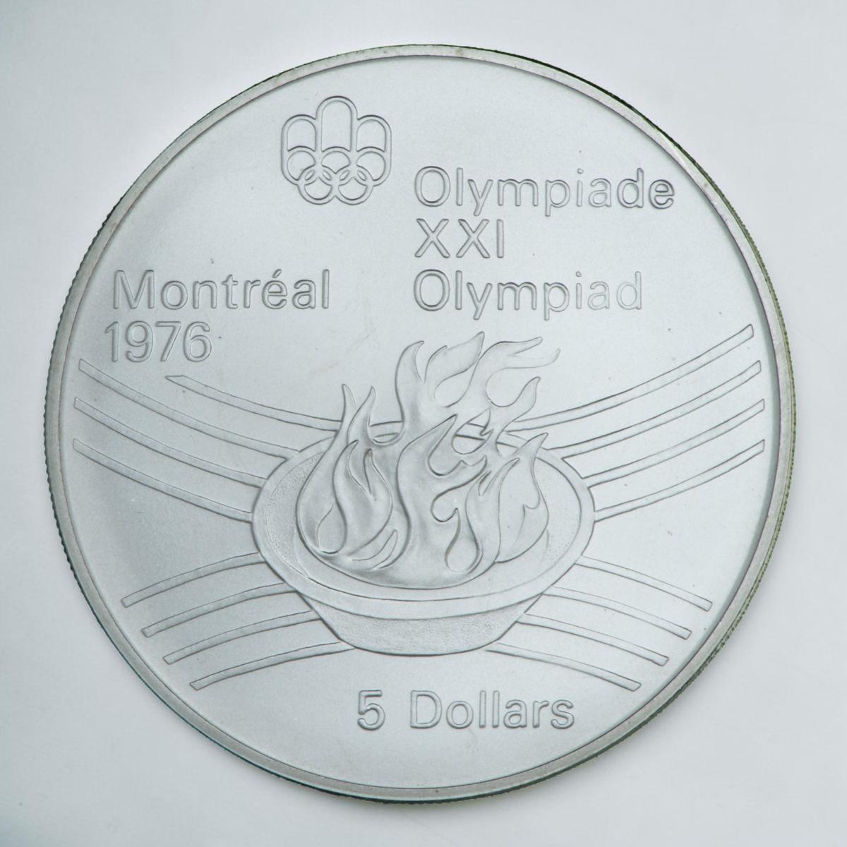 Coin, silver, shallow bowl with stylized flames bursting upwards, curved line motif behind.
