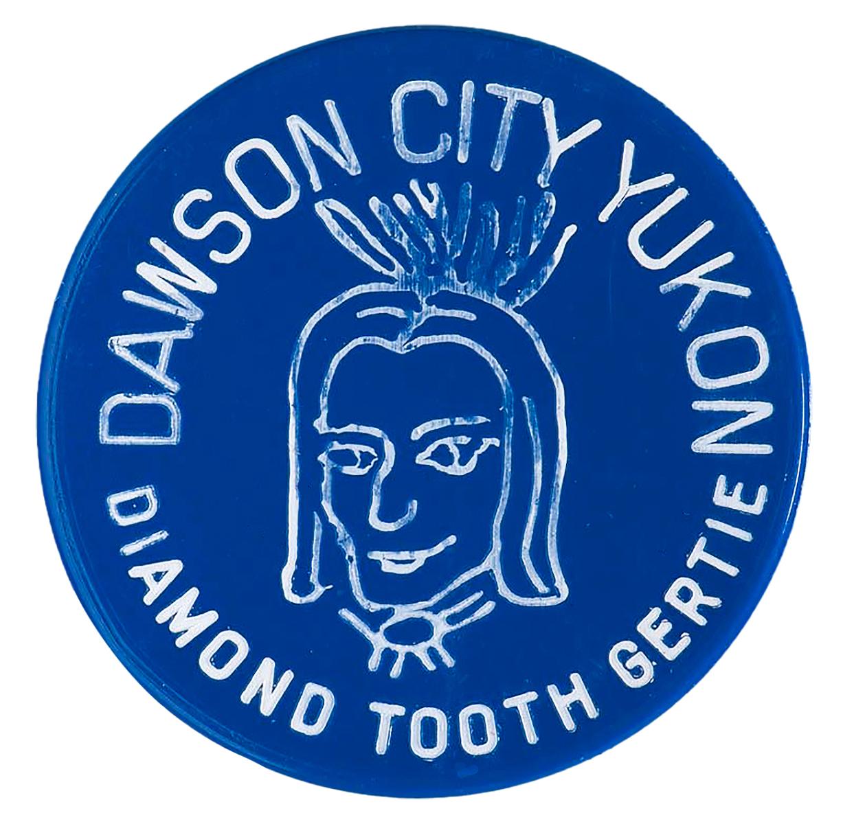 Gambling token Token, round, plastic, blue with head of woman with elaborate headdress, says “Diamond Tooth Gerties”.