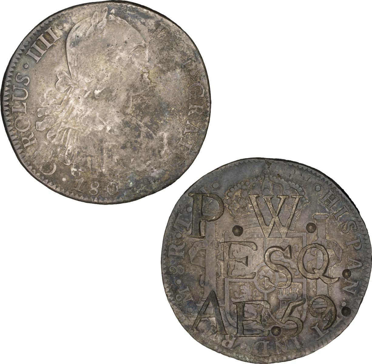 Countermarked Spanish-American coin Back of gray coin with letters and numbers punched into surface. Front of gray coin, head of man facing right, inscription around rim.